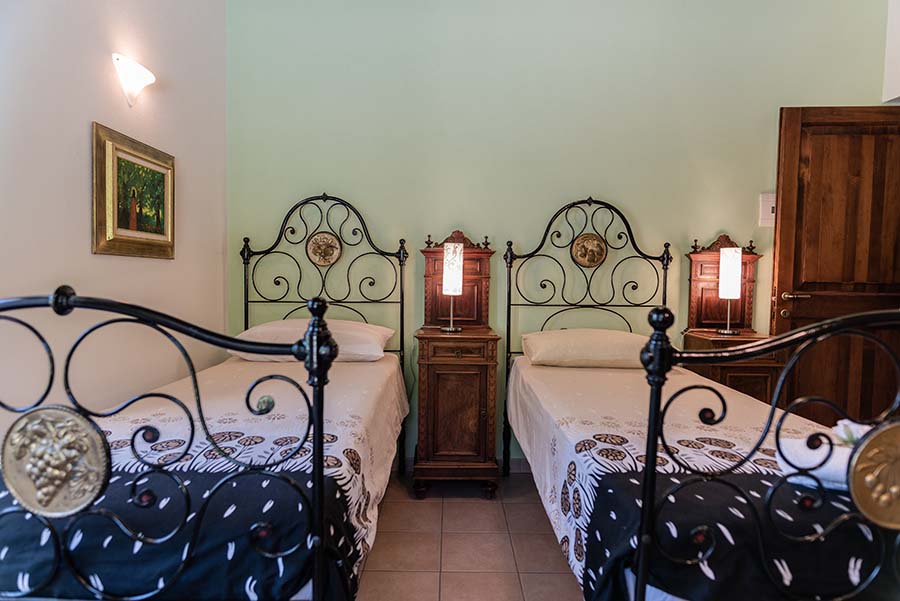 Twin bedroom with traditional iron bed frames