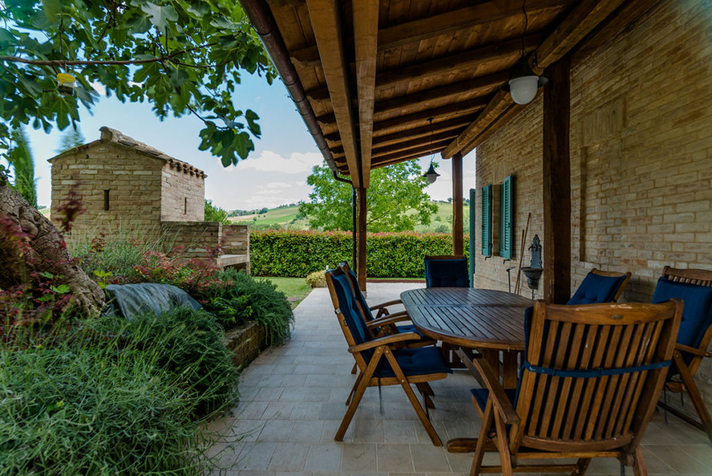 Outdoor dining table under the covered pergola