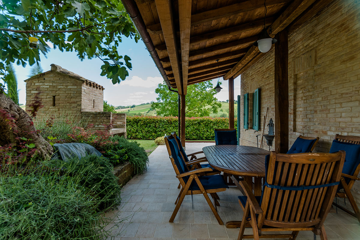 Outdoor dining table under the covered pergola